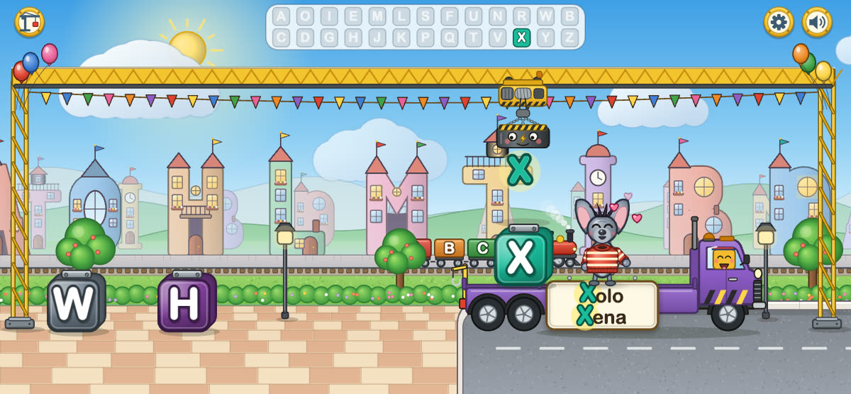 The alphabet crane lifts a letter onto a truck, next to a dragonfly.